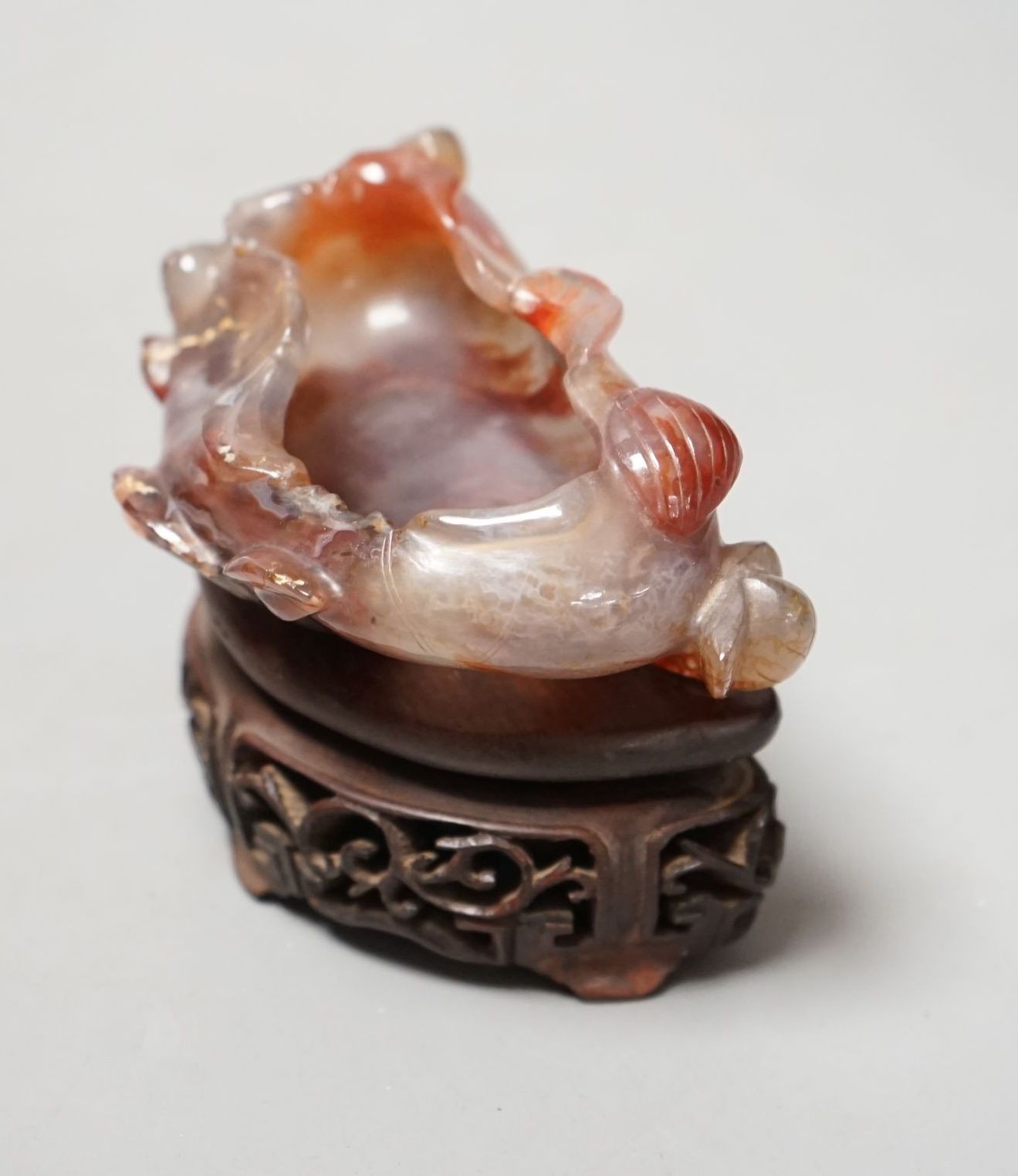 A late 19th / early 20th century Chinese agate brushwasher, wood stand - 8cm tall